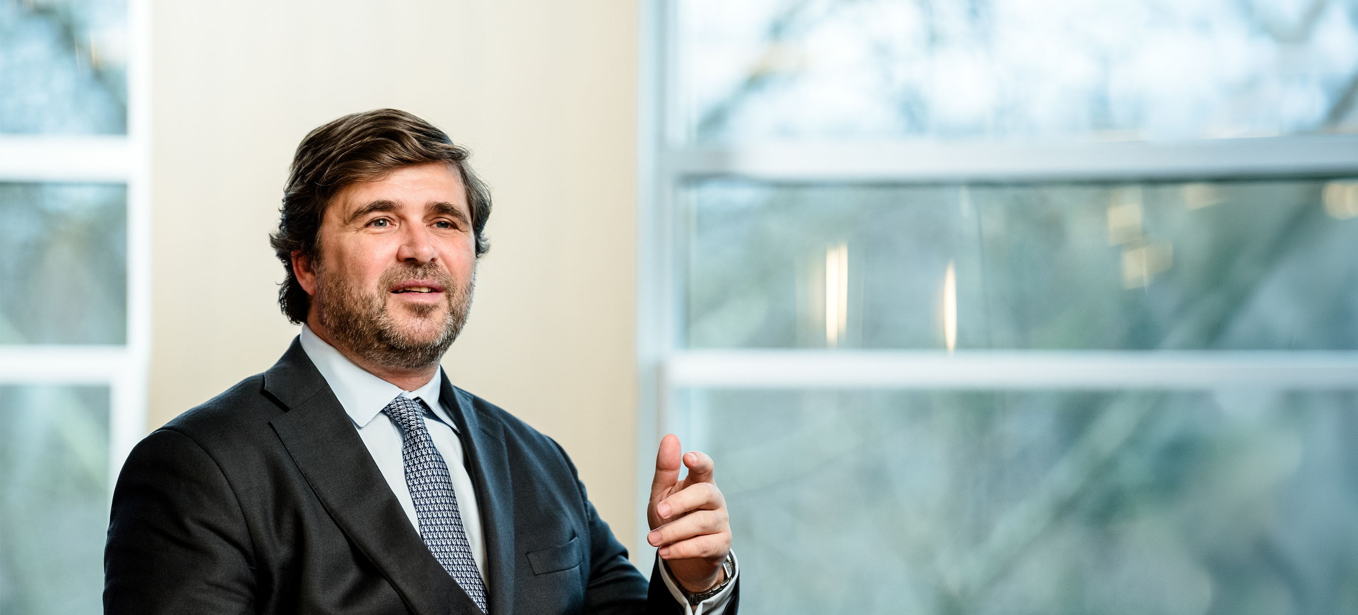 Portrait photo of a suited man gesturing