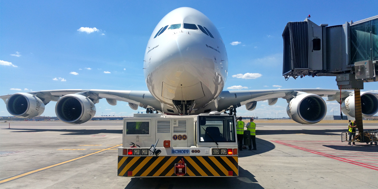 Front view of large commercial airplane on airport tarmac